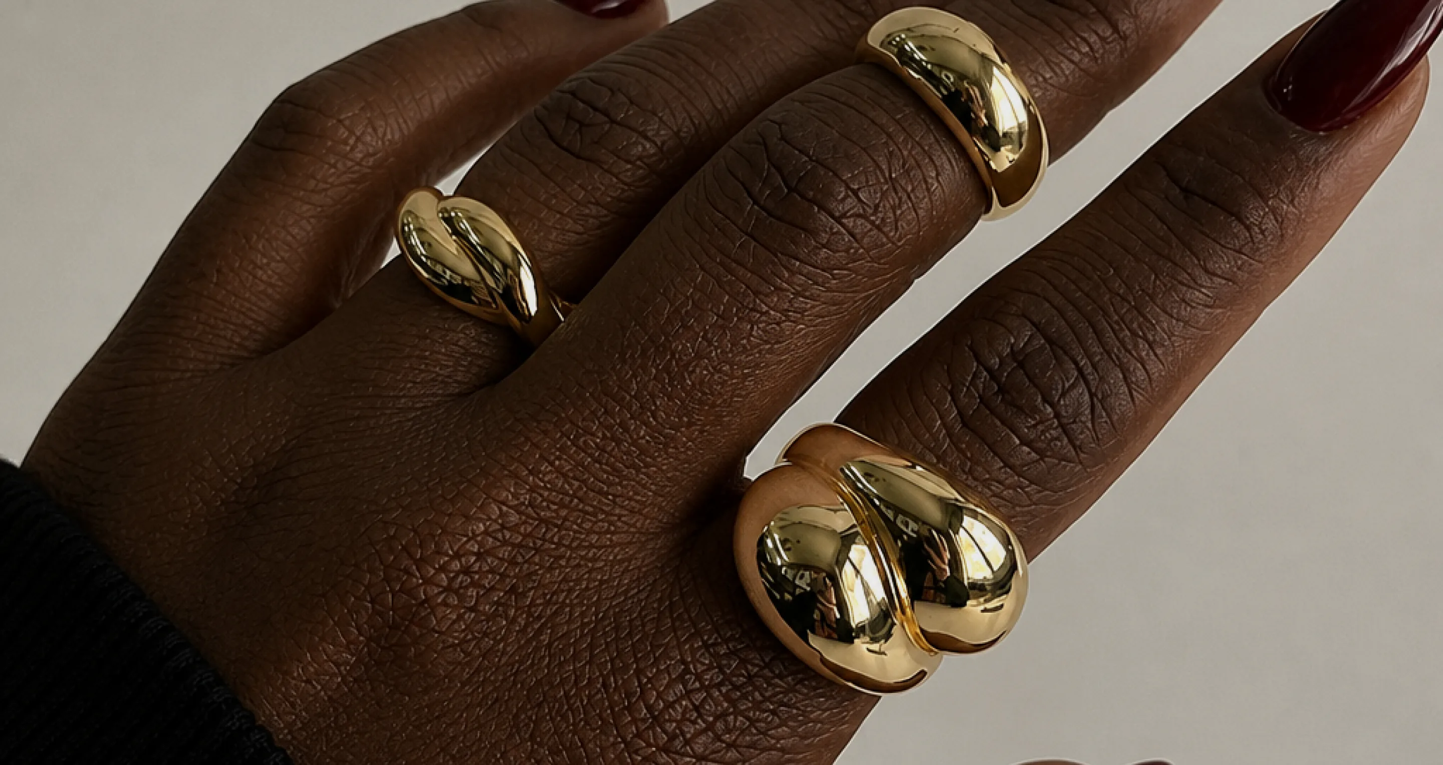 A hand styled with gold House of Martha rings